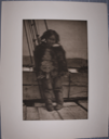 Image of An Eskimo girl standing, probably aboard ship