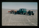 Image of Tractor and jeep with trailer were the field transports to prepare runway.
