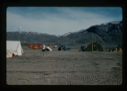 Image of Centrum Lake base camp including 2 US helicopters and vehicles.