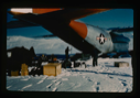Image of Unloading C-130 aircraft at Centrum Lake on snow. Vehicles plus equipment