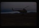 Image of US Navy helicopter from USS Atka airlifting jeep trailer over Polaris Promontory