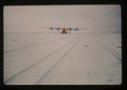 Image of C-130 test landing on snow-covered airstrip.