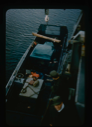 Image of Lowering jeep and equipment into landing barge from U.S.S. Atka 