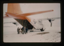 Image of Personnel load patient Dr. Weidick aboard the C-130 test aircraft.
