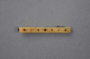 Image of Flat rectangular ivory hair clip with pattern of dots