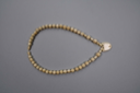 Image of Ivory necklace with 53 tubular-shaped beads, heart-shaped bead at center