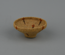 Image of Coiled grass basket with flower design, narrow base and wide top edge