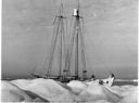 Image of The Bowdoin anchored to an iceberg