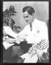 Image of Lowell Thomas seated before NBC microphone - autographed