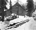 Image of MacMillan Scientific Station with snow on ground, lumber and other supplies
