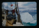 Image of The Bowdoin maneuvering beside iceberg