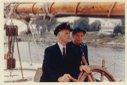 Image of Donald and Miriam MacMillan at wheel of Schooner Bowdoin