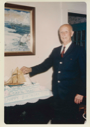 Image of Donald MacMillan standing by his 90th birthday cake