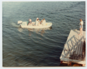 Image of Group in motorboat approaching float
