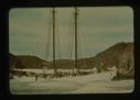 Image of The Bowdoin moored near ice. Crew on deck