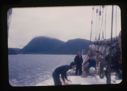 Image of Miriam MacMillan and two crewmen on deck. 