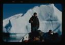 Image of Crewman in small boat by iceberg