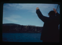 Image of Miriam MacMillan waving goodbye to Eskimos [Inuit] on a bluff (2 copies)