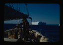 Image of Miriam MacMillan at wheel. Iceberg beyond (2 copies)