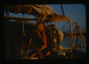 Image of Miriam MacMillan at wheel, wth sunset colors