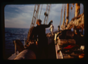 Image of Miriam MacMillan on deck with codfish caught on jig (2 copies)