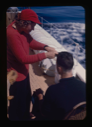 Image of Miriam MacMillan cutting hair on deck
