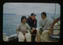 Image of Two Inuit women and Miriam MacMillan by wheel