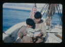Image of Two Eskimo [Inuit] boys aboard look at "Etuk, The Eskimo [Inuit] Hunter"