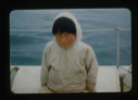 Image of Eskimo [Inuk] boy in anorak, aboard (2 copies)