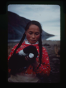 Image of Eskimo [Inuk] girl with long braids, holding young pup (2 copies)