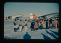Image of Eskimos [Inuit] lined up by air force planes