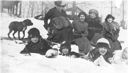 Image of 4 children and 4 women, with dog, in snow. Includes Miriam, Laura, Amy Look