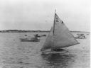 Image of Sailboat under sail, other boats near