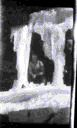 Image of 2 white men by icicles from bluff