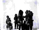 Image of Inuit women, and children holding dog on a lead