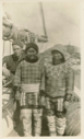 Image of Donald Mix an two Inuit women in traditional garb, at wheel