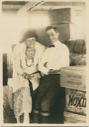 Image of Ralph Robinson and his mother? among supplies for the Bowdoin