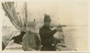 Image of Crew man in headnet and Thomas McCue with pistol - on deck