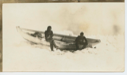 Image of Thomas McCue and Donald Mix sitting on gunwale of dory in ice