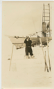 Image of Thomas McCue near iced-in Bowdoin, using theodolite [sextant]