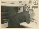 Image of Donald MacMillan in Bowdoin chart room, studying charts