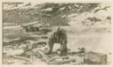 Image of Inuit man repairing sledge