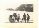 Image of Group of Greenlanders and two servicemen around kayaks