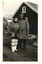 Image of Greenlandic woman in traditional dress, with serviceman