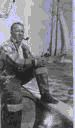 Image of Donald MacMillan at the compass. Dr. William Thomas behind