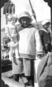 Image of Eskimo [Inuk] girl aboard, holding large doll - a gift from Donald MacMillan