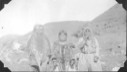 Image of Eskimo [Inuit] man and two women at mouth of Sylvia Grinnel River