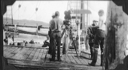 Image of Crewman on dock with movie equipment