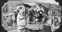 Image of Four Eskimo [Inuit] girls in furs, blowing up balloons