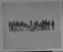 Image of Inuit men, women, children by sledge with odometer 